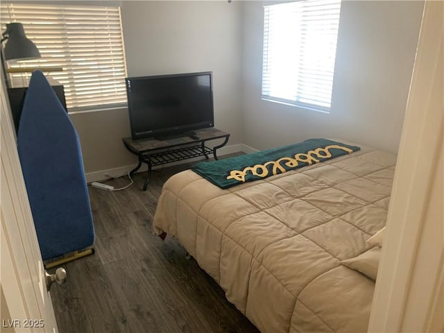 bedroom with wood finished floors and baseboards