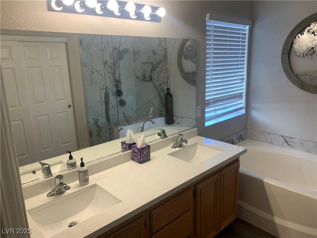 bathroom with double vanity, a bath, a marble finish shower, and a sink