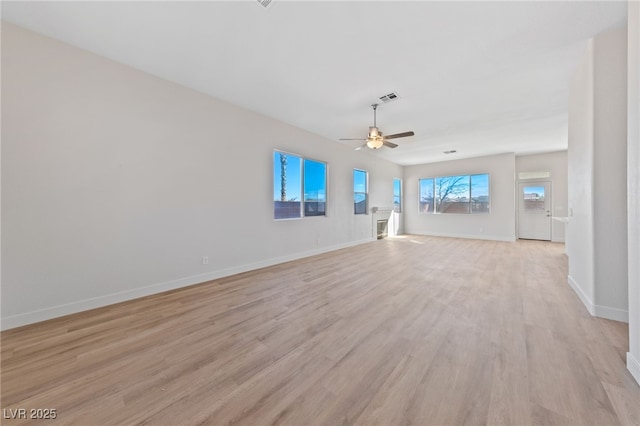 unfurnished living room featuring light wood-style floors, baseboards, visible vents, and a ceiling fan