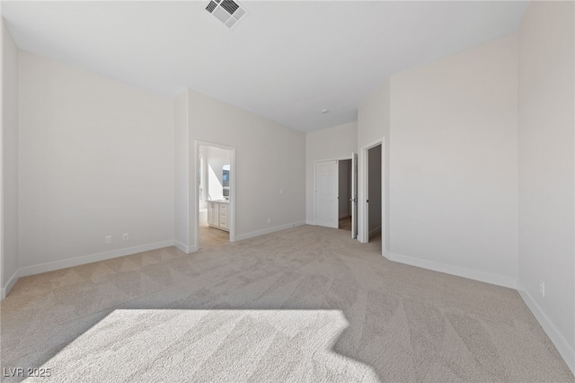 unfurnished bedroom with visible vents, light carpet, baseboards, and ensuite bathroom