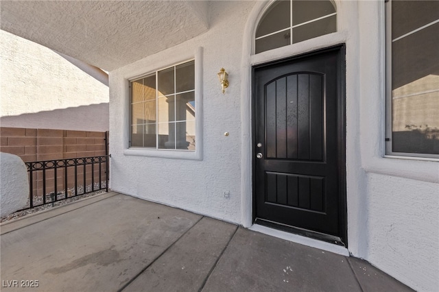 view of exterior entry featuring stucco siding