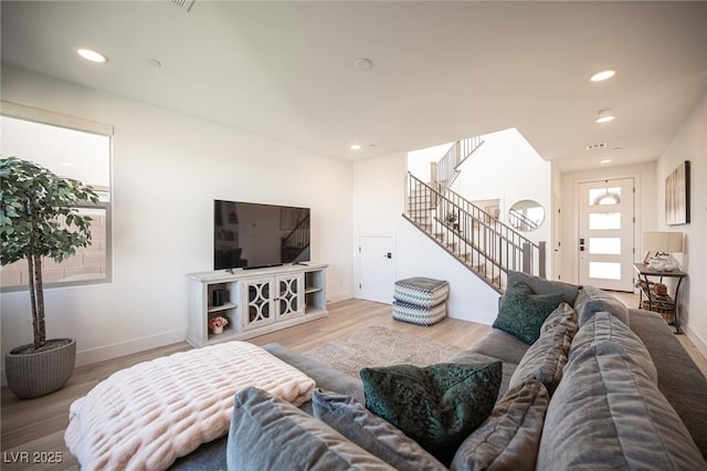 living area with stairs, baseboards, wood finished floors, and recessed lighting