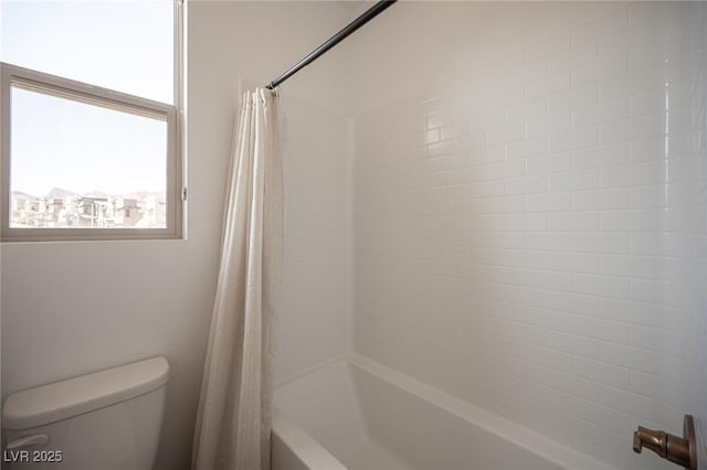 bathroom featuring toilet and shower / tub combo