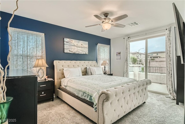 bedroom featuring access to exterior, visible vents, light carpet, and a ceiling fan