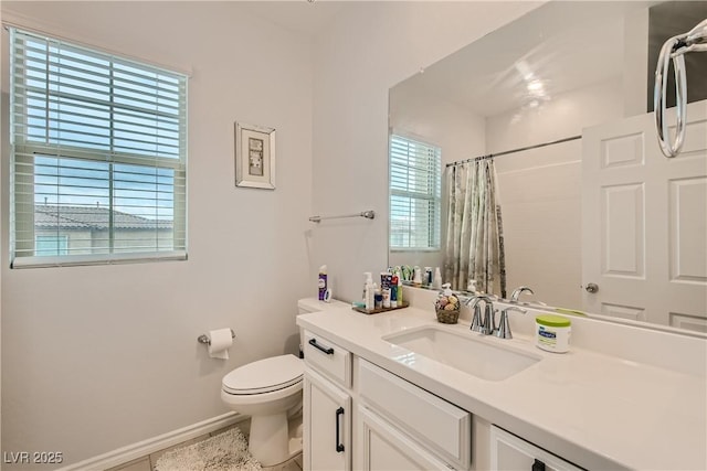 bathroom with baseboards, a shower with shower curtain, vanity, and toilet