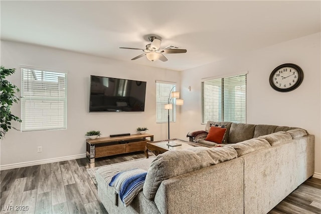 living room with ceiling fan, baseboards, and wood finished floors