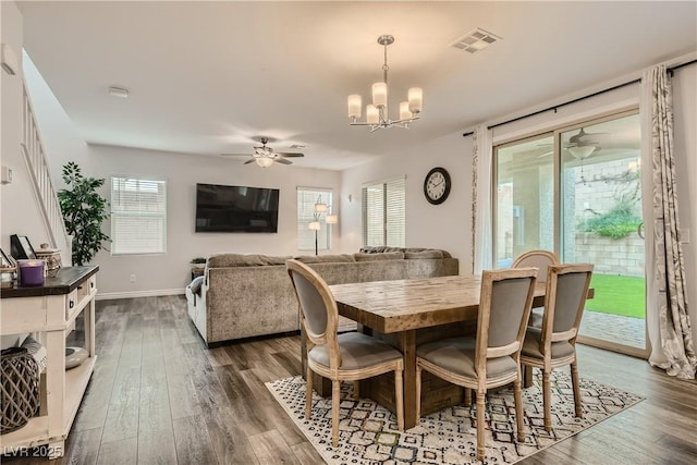 dining room with dark wood-style floors, visible vents, and a healthy amount of sunlight