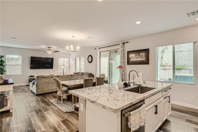 kitchen with dark wood-type flooring, a sink, visible vents, white cabinetry, and stainless steel dishwasher