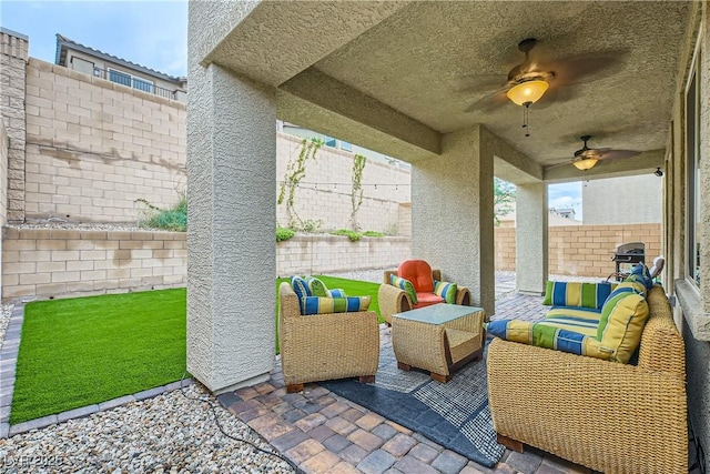 view of patio / terrace with a fenced backyard, ceiling fan, and an outdoor living space