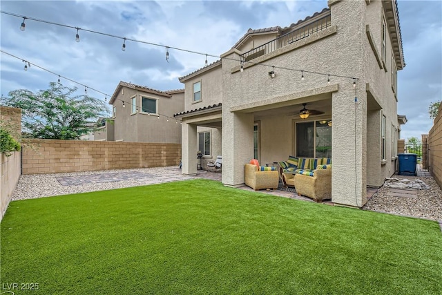 rear view of house with a patio, a fenced backyard, an outdoor hangout area, a yard, and stucco siding