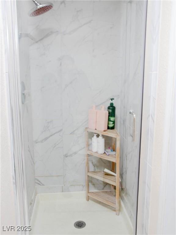 full bath with a marble finish shower