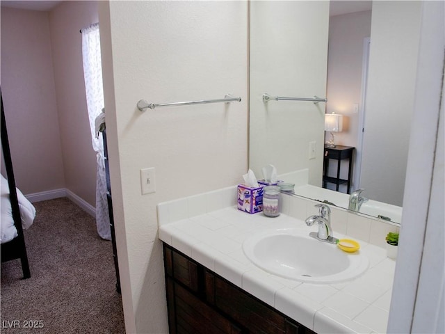 bathroom featuring vanity and baseboards