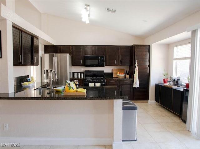 kitchen featuring dark brown cabinetry, a peninsula, visible vents, vaulted ceiling, and black appliances