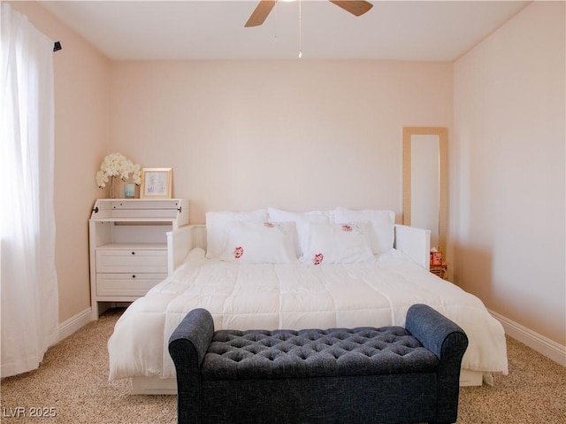 carpeted bedroom with a ceiling fan and baseboards