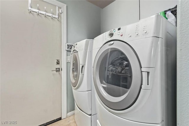 laundry room with washing machine and clothes dryer and laundry area