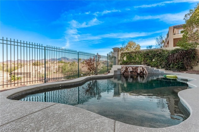 view of swimming pool featuring fence and a fenced in pool