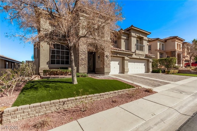 view of front of house with driveway, an attached garage, stucco siding, a tile roof, and a front yard