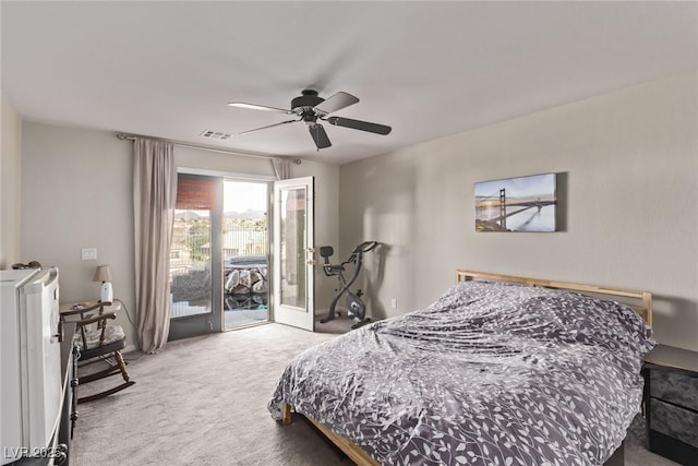 carpeted bedroom with access to outside, a ceiling fan, and visible vents