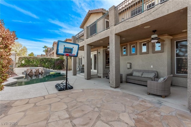 view of patio / terrace featuring an outdoor living space, a balcony, a fenced in pool, and ceiling fan