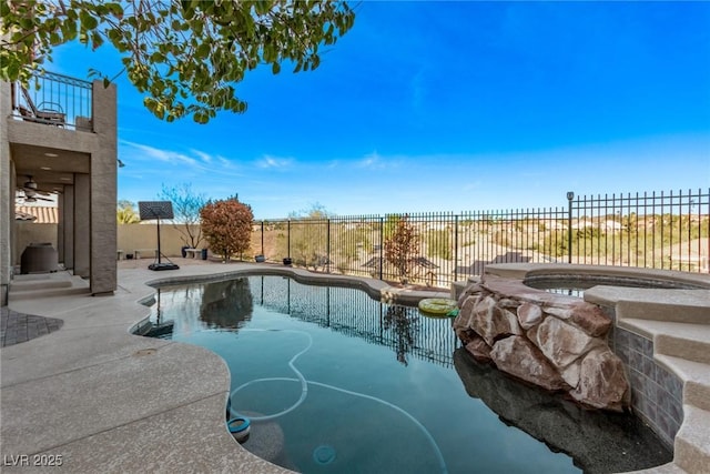 view of pool featuring a patio area, an in ground hot tub, a fenced in pool, and a fenced backyard