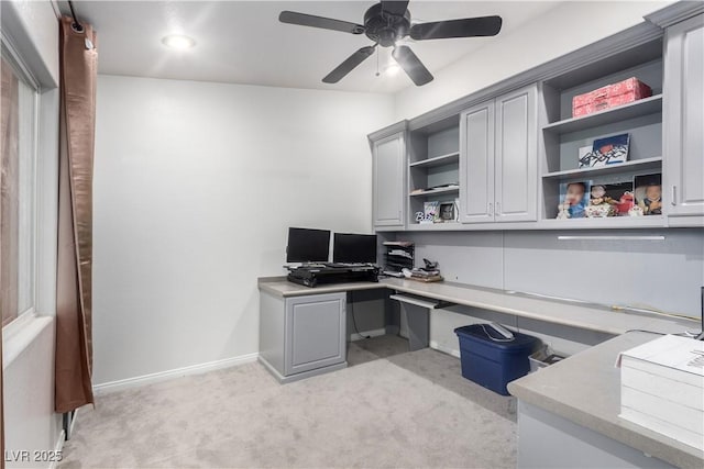 office space featuring built in desk, light colored carpet, recessed lighting, a ceiling fan, and baseboards