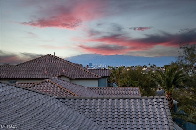 exterior details with a tiled roof and a mountain view