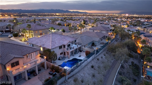 aerial view at dusk with a mountain view and a residential view