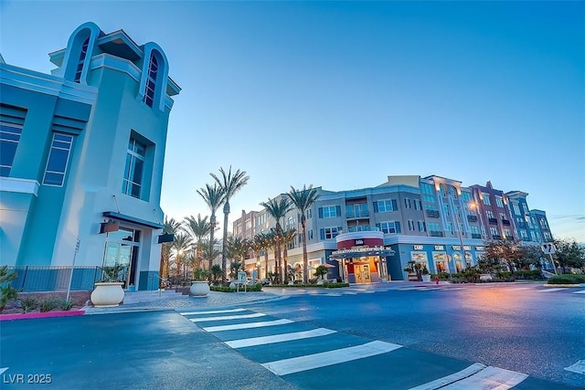 view of road featuring sidewalks, curbs, and street lights