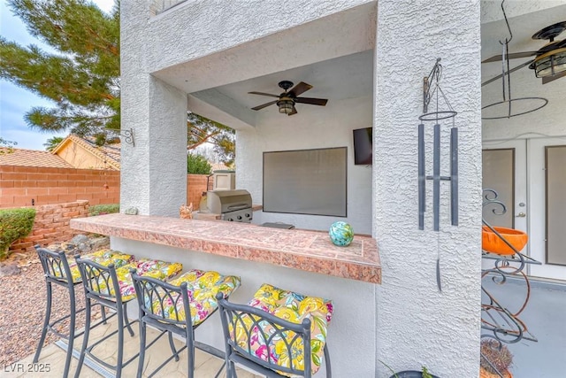 view of patio featuring ceiling fan, fence, and area for grilling