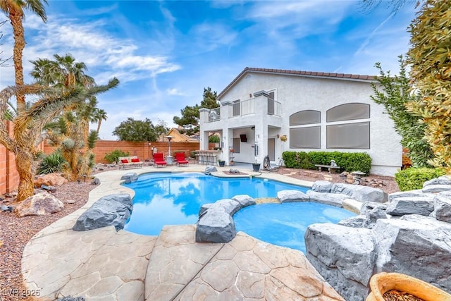 view of pool with a patio area, a fenced backyard, and a pool with connected hot tub