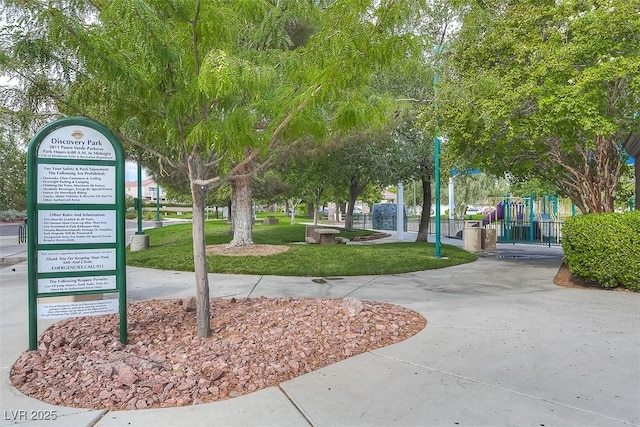 view of home's community with playground community and a lawn