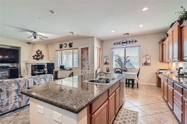 kitchen featuring a healthy amount of sunlight, light tile patterned floors, visible vents, and a sink