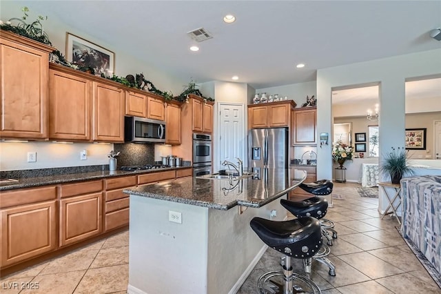 kitchen with light tile patterned floors, visible vents, stainless steel appliances, and a sink