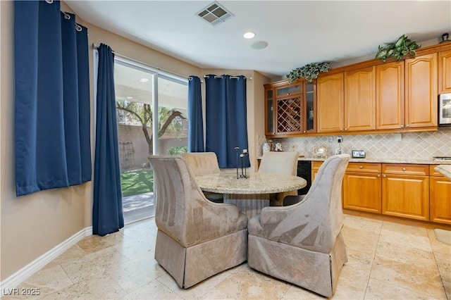 dining area with baseboards, visible vents, stone tile flooring, and recessed lighting