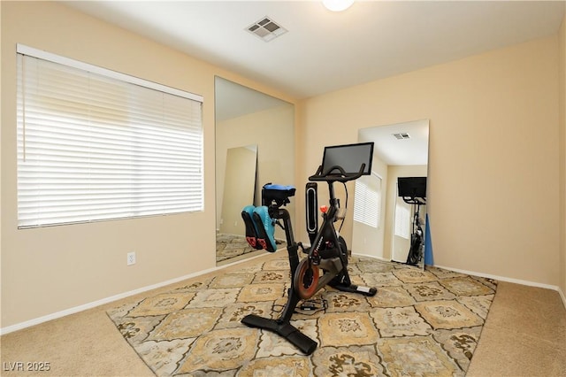 exercise area with carpet, visible vents, and baseboards