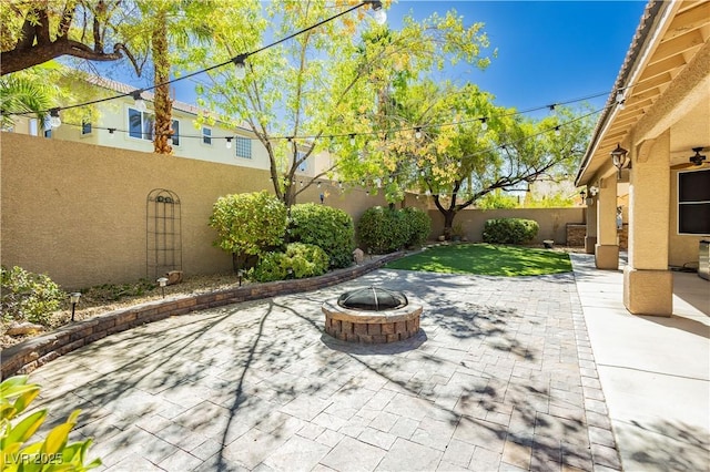 view of patio / terrace with a fire pit and a fenced backyard