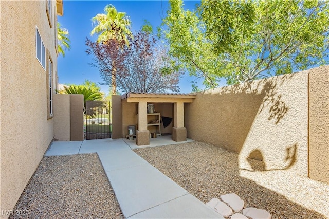 view of patio with a gate and fence