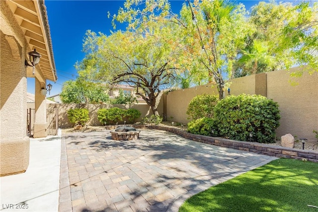 view of patio / terrace with a fenced backyard and a fire pit