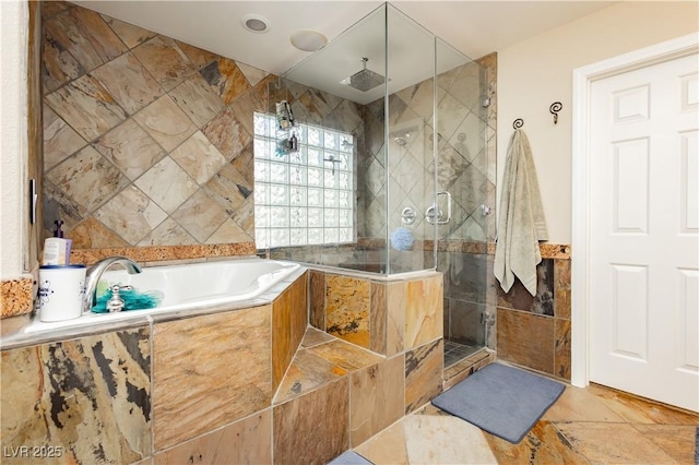 bathroom featuring a shower stall, a bath, and tile walls