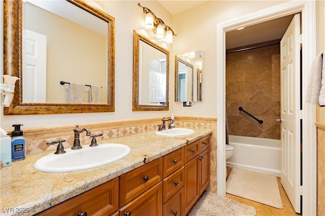 full bathroom with washtub / shower combination, double vanity, a sink, and toilet