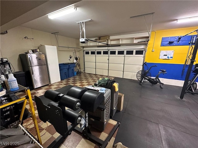 garage with freestanding refrigerator and a garage door opener