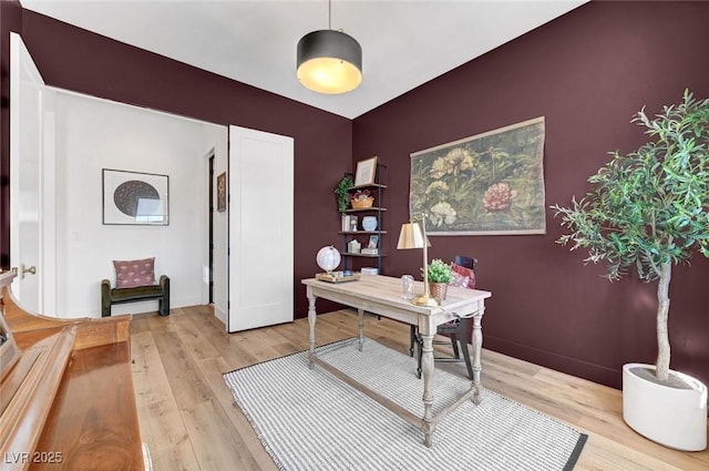 office area featuring light wood-type flooring and baseboards