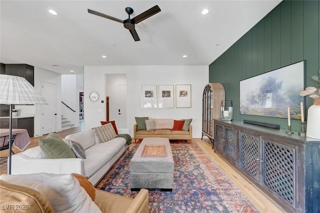 living room with recessed lighting, ceiling fan, stairway, and light wood finished floors