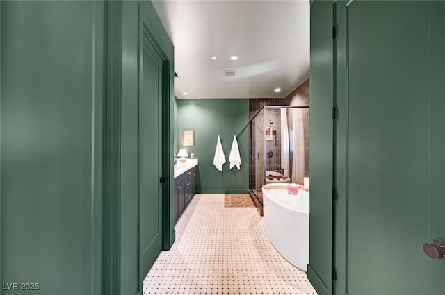 full bath with a stall shower, visible vents, a soaking tub, tile patterned floors, and vanity