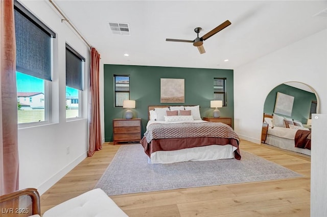 bedroom with ceiling fan, recessed lighting, wood finished floors, visible vents, and baseboards