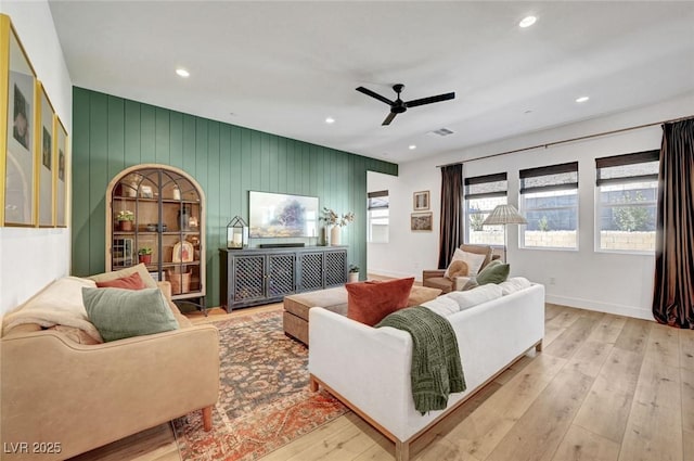 living area with hardwood / wood-style flooring, baseboards, a ceiling fan, and recessed lighting