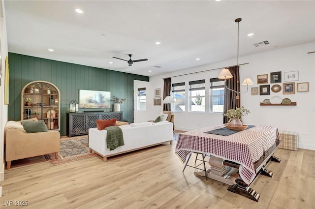 living area featuring baseboards, visible vents, ceiling fan, wood finished floors, and recessed lighting