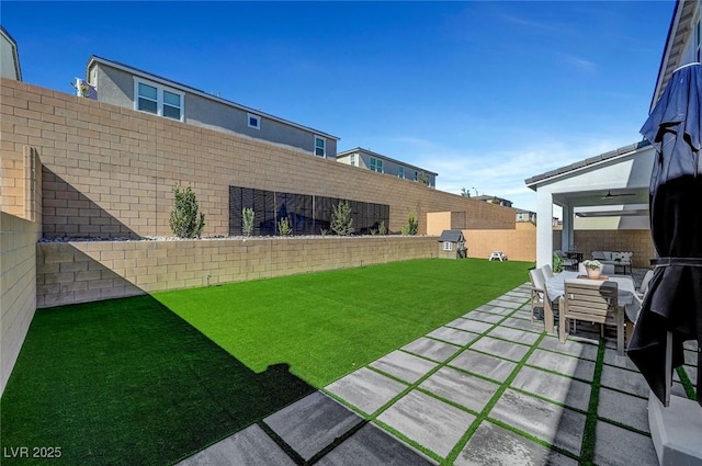 view of yard featuring a patio area, a fenced backyard, and an outdoor hangout area