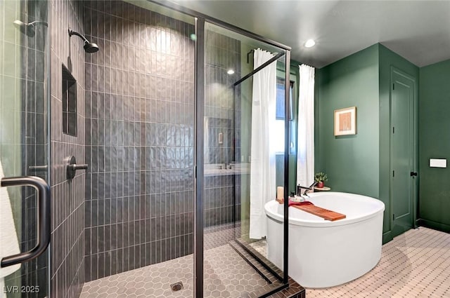 bathroom with tile patterned flooring, a freestanding bath, and a shower stall