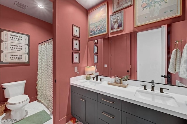 full bath with visible vents, a sink, toilet, and double vanity